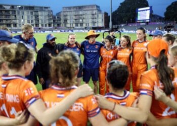 An orange bus dinghy leads march in Bristol for women’s cricket